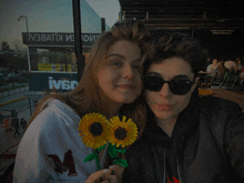 a boy and a girl are posing for a picture in front of a building that says ivso