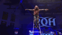 a wrestler is laying on a table in front of a sign that says roh on it