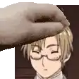 a close up of a person 's hand touching a man 's head .