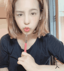 a woman with a stick figure on her arm holding a pink pen