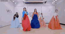 a group of women are dancing in front of a vine entertainment sign