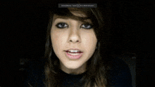 a blurry picture of a girl 's face with a black background