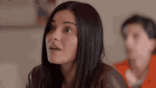 a woman with a surprised look on her face looks up