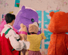 a group of children are standing around a stuffed animal .