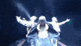 three men are dancing on a stage with their shirts off