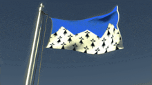 a blue and white flag with mountains on it is flying in the wind