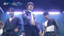 a group of young men are dancing on a stage with a purple background that says ' 2019 x k-la ' on it