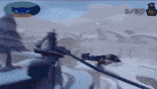 a cartoon character is holding a gun in a snowy scene .