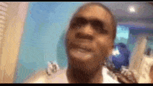 a blurry picture of a person 's face with a blue background