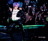 a man with purple hair is dancing on a stage with slow but steady written below him