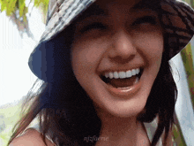 a close up of a woman wearing a hat with the name njzfaerie on the bottom right