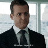 a man in a suit says give him my office