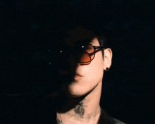 a close up of a man wearing sunglasses with red lenses