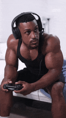 a man wearing headphones is playing a video game with the year 2018 in the corner