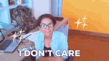 a woman sitting at a desk with the words " i don 't care " written below her
