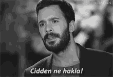 a black and white photo of a man with a beard and the words cidden ne hakka