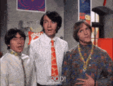 three men standing next to each other and one of them says food