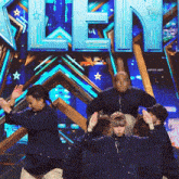 a group of people are dancing in front of a sign that says ' talent '