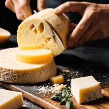 a person is cutting a piece of cheese with a knife on a wooden cutting board .
