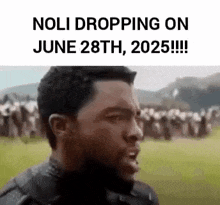 a black panther is standing in front of a crowd of people in a field .