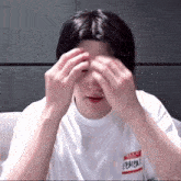 a person wearing a white shirt with a name tag that says ' hello ' on it