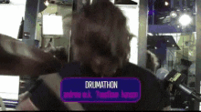 a person with a sign that says drumathon