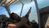 a man in a helmet is pointing at the sky