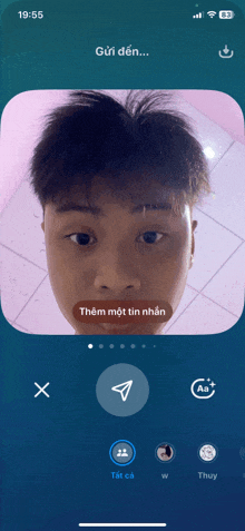 a phone screen shows a man 's face with the time 19:55 on it