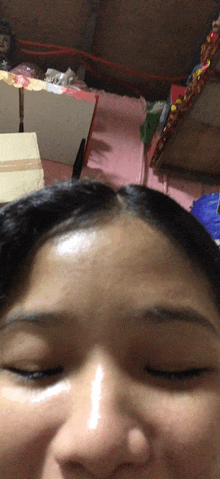 a close up of a woman 's face with closed eyes
