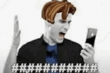 a man with a wig on his head is holding a cell phone and shouting .