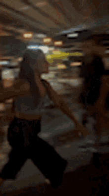 a blurry picture of a woman standing next to a man .