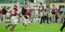 a football player wearing number 22 is running with the ball