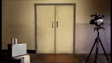 a camera on a tripod in front of a door that says ' nbc news ' on it