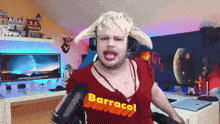 a man is wearing a red shirt that says barracol on it