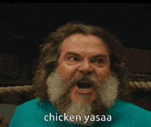 a man with long hair and a beard says chicken yasaa in front of him