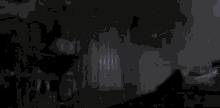 two men are standing next to each other in a dark room .