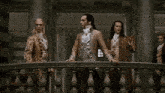 a man with long hair stands between two other men