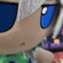 a close up of a cartoon character 's face with white hair and blue eyes