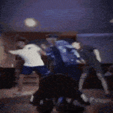 a blurry picture of a group of people dancing in a room with the word virgin on the floor