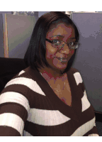 a woman wearing glasses and a brown and white striped sweater smiles for the camera