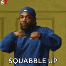 a man wearing a blue hat and a blue hoodie says squabble up