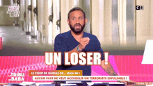 a man sitting at a desk with the words un loser written on the screen