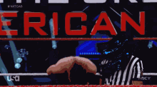 a referee stands in front of a sign that says " erican "