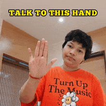 a person wearing a shirt that says turn up the music