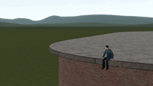 a man is sitting on the edge of a brick wall