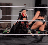 a woman in a cowboy hat stands in a ring