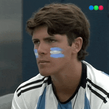 a man with blue and white painted on his face