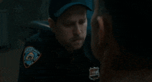 a police officer is talking to a man in a prison uniform