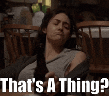 a woman is holding a beer bottle with the words that 's a thing written below her