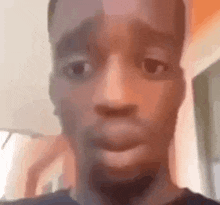 a close up of a young man 's face with a blurred background .